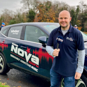 presenter from nova next to radio nova car