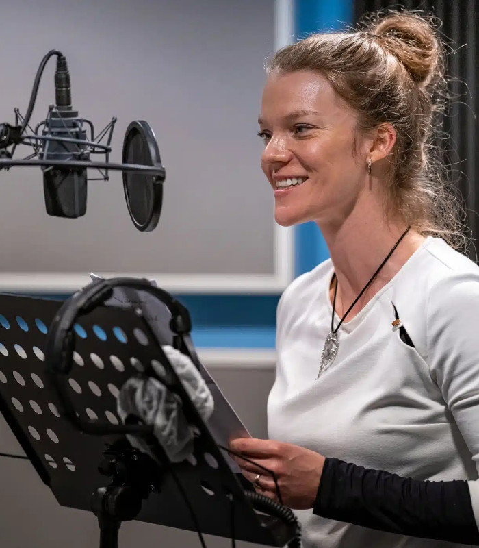 woman recording in a radio station studio